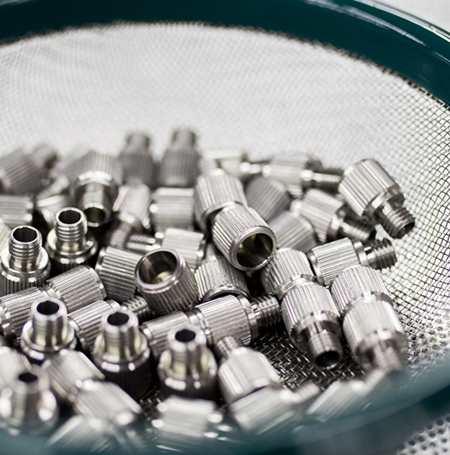 Close-up view of precision machined stainless steel parts by VF Decolletage
