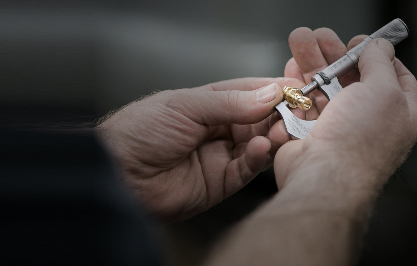 AVF Decolletage QC staff checking part dimensions with manual caliper