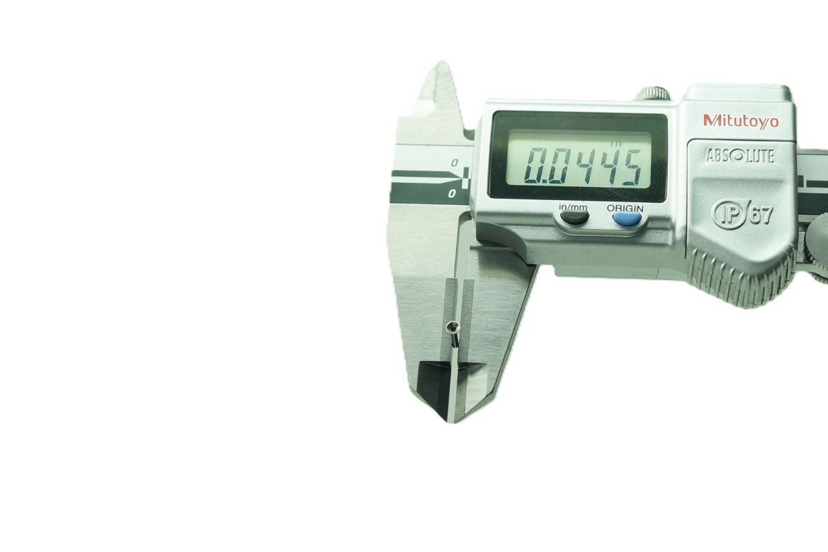 AVF Decolletage QC staff measuring precision part with Mitutoyo digital caliper